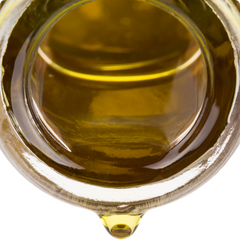 Mouth of amber bottle with oil drop, best face oil for dry skin