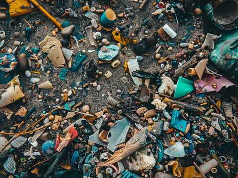 A Top Shot Of A Beach With Plastic Products Litter