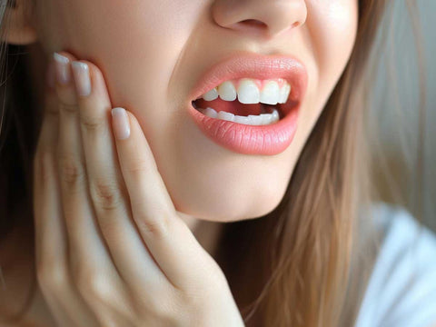 A woman having painful teeth