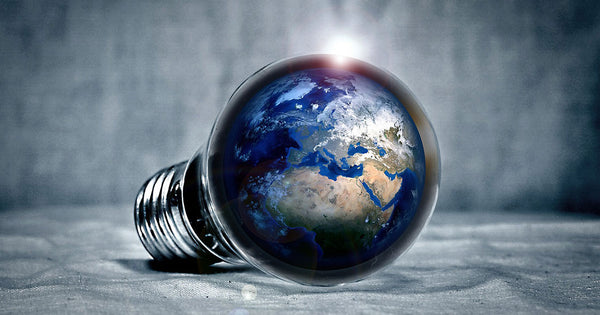 a fictionary picture of a light bulb filled with the planet Earth