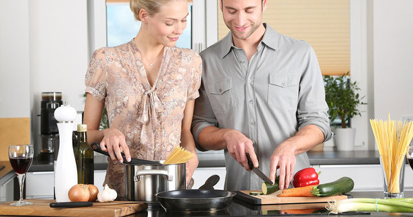 A couple cooking together in their eco-friendly kitchen