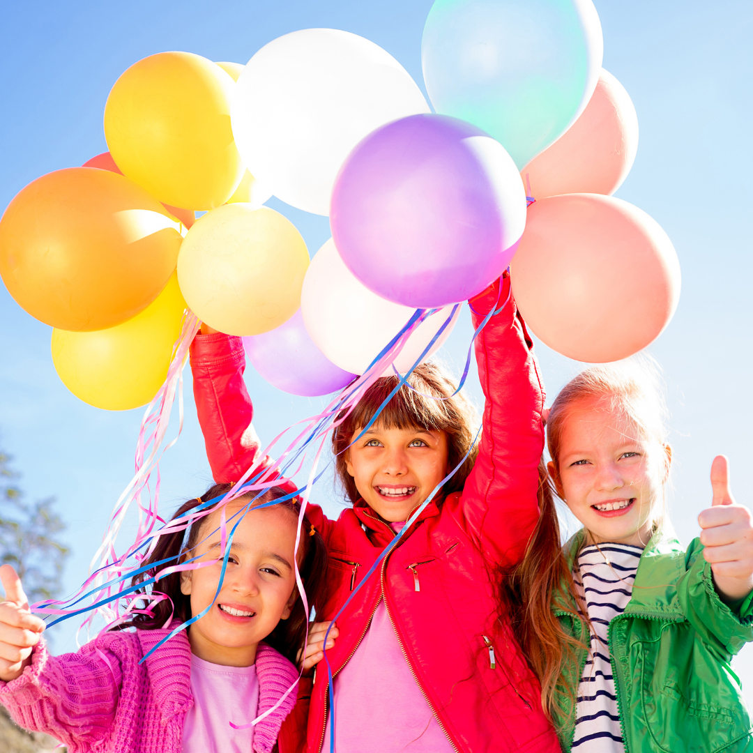 Kids with colourful balloons.