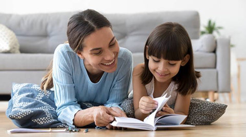 Mother and daughter reading a book.