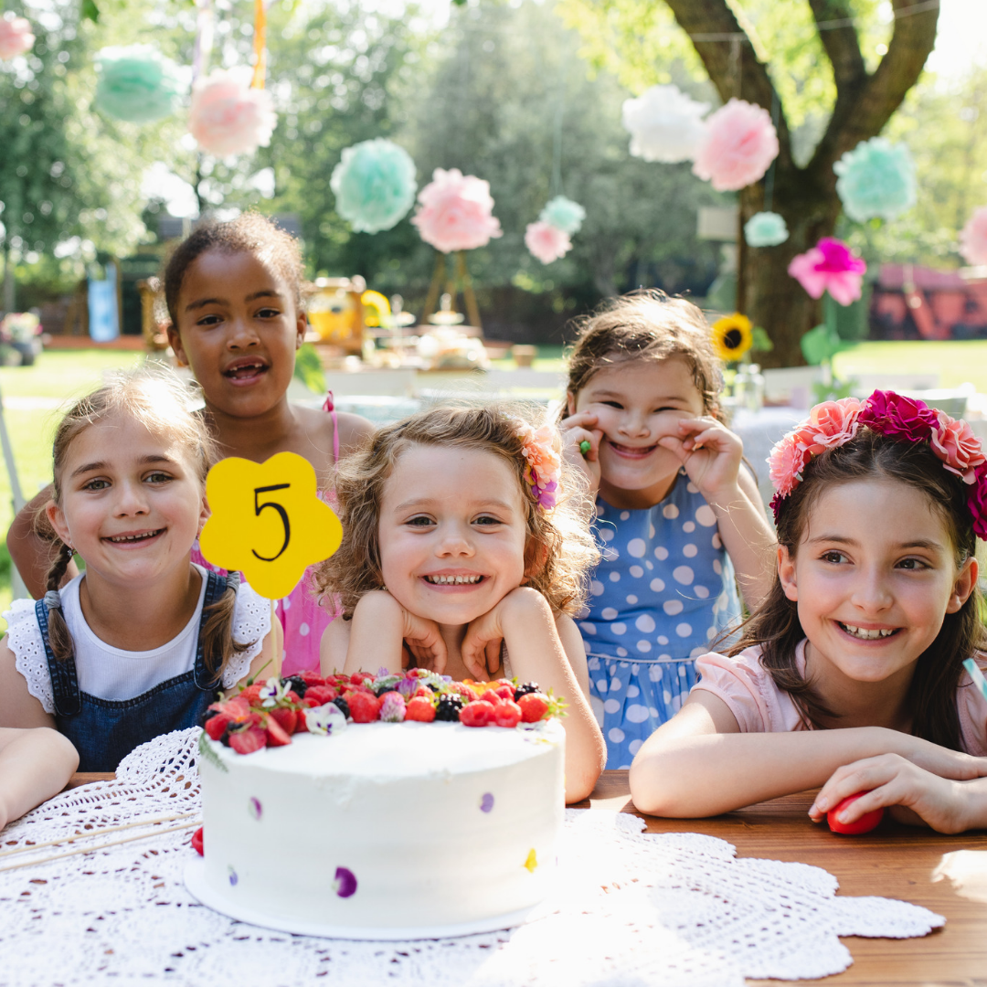 A girl celebrating her 5th birthday with her friends.
