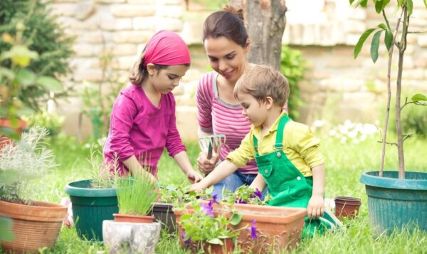Kids doing gardening with their mom.