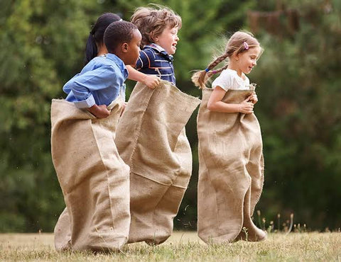 3 kids playing sack race.