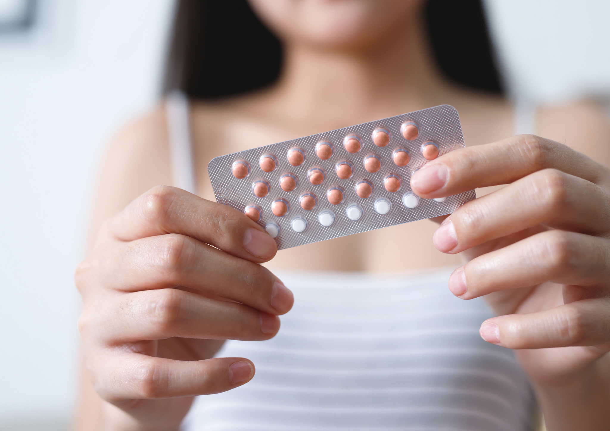 A lady holding drugs.