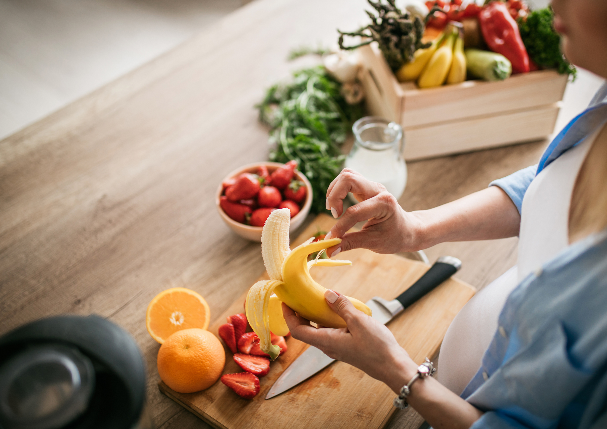 A lady peeling banana.