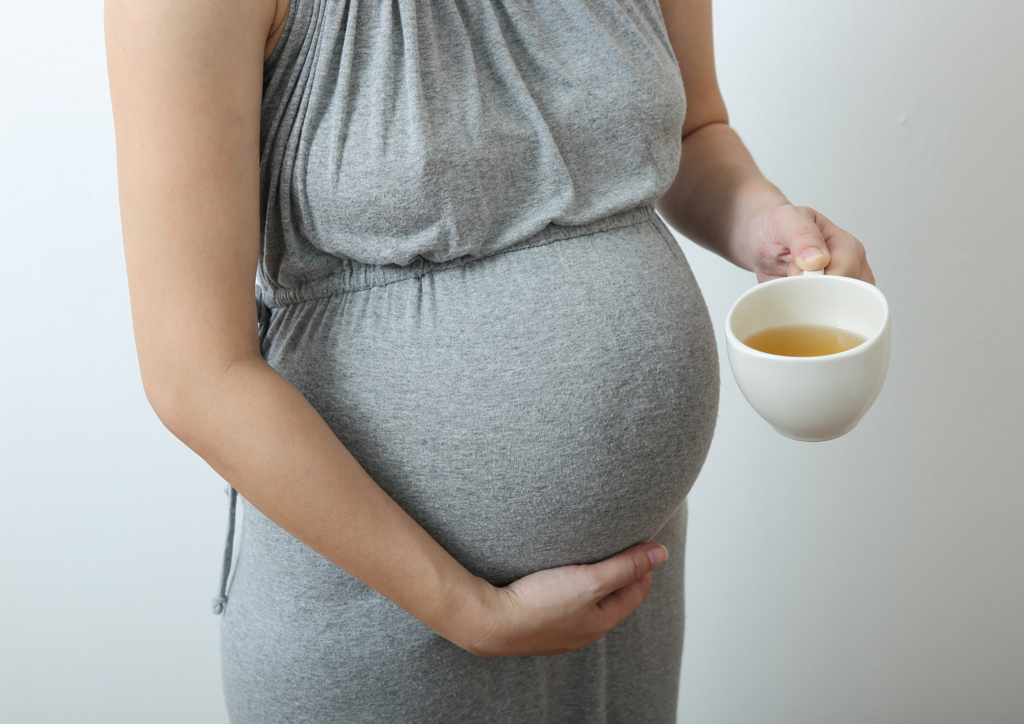 Pregnant lady taking coffee.