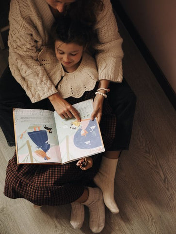 A mom reading to her kid.