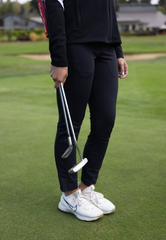 A woman wearing dark colored golf pants for women