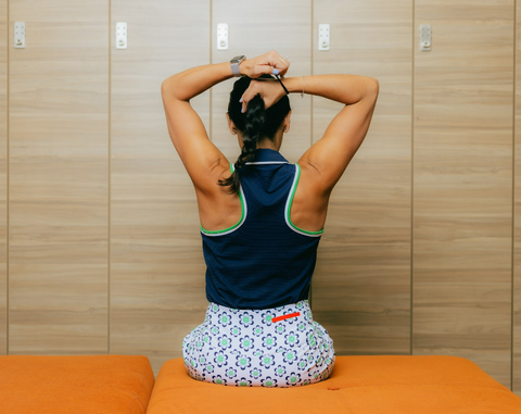 A woman stretching in the locker room