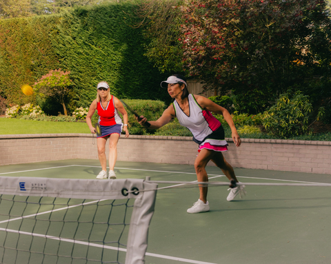 Two women playing a game of pickleball