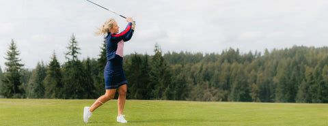 A woman wearing a blue skirt and matching long-sleeved jacket