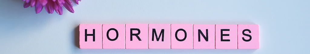 Hormones written across pink scrabble tiles
