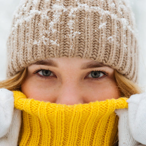 Woman with hat and scarf with snowflakes