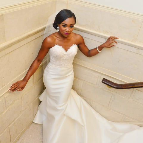 Gorgeous Black woman in a white mermaid wedding gown that was altered with the perfect fit for her body by Margo West