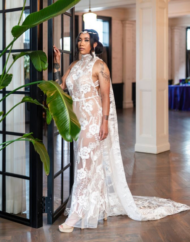 Lace wedding jumper with royal cape on a beautiful woman by Margo West in a window by a tree