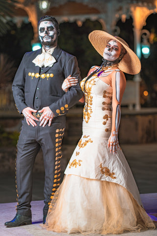 Couple on dia de los muertos as bride and groom celebrating their culture.
