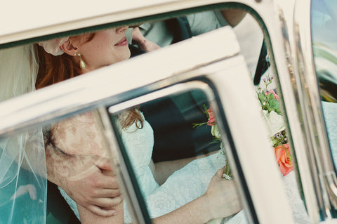 Beautiful bride ready for her wedding planning journey dreaming of her perfect custom wedding dress in a car