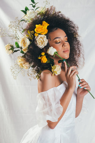 Beautiful bride with yellow and orange flowers in her hair