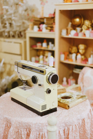 Sewing machine in a work room for custom made wedding gowns