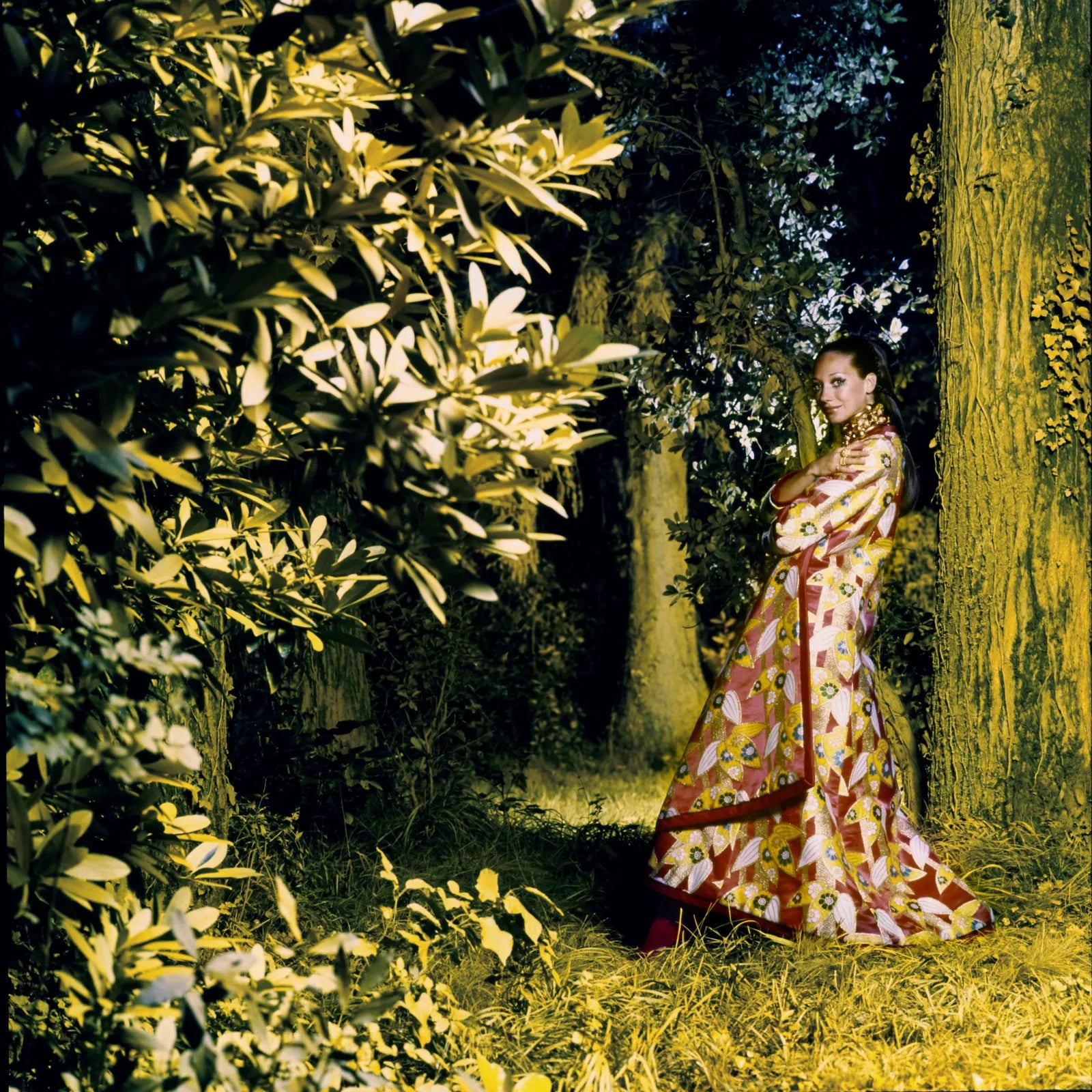 Marisa Berenson wears a red silk brocade kimono coat by Hanae Mori in the gilded forest of the Chateau d’Arcangues. Photographed by Arnaud de Rosnay, Vogue, November 1, 1968