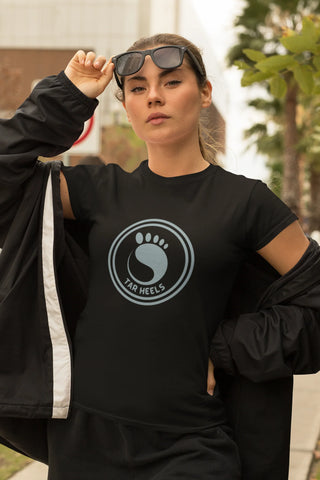 Schools Clothing, T-shirts, Gifts. Young woman wearing a school emblem t-shirt and lifting her sunglasses.