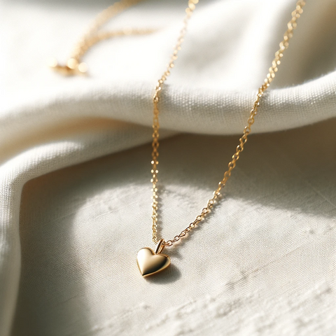 A classic gold necklace with a thin, delicate chain and a small, elegant heart-shaped pendant, capturing the simplicity and charm of Scandinavian design.