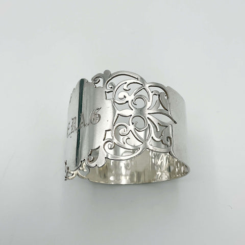Shiny napkin ring with elaborate sides and EDAG in the centre on a plain background