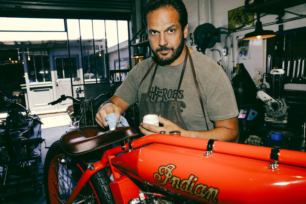 serge bueno putting oil on a motorcycle saddle