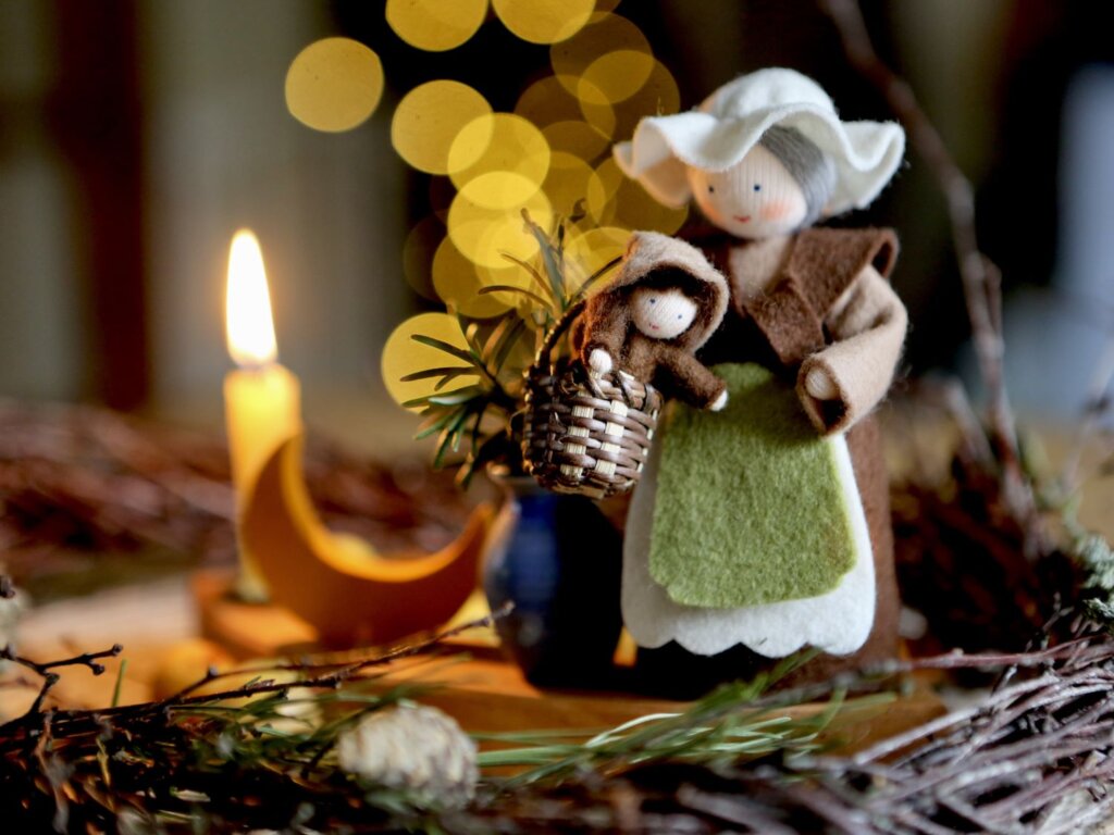 Giving thanks to our female ancestors on Mother's Night with an Ambrosius felt doll of Mother Earth and a lit candle in the background. Mother's Night marks the start of the 12 days of Yuletide