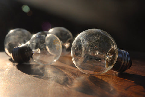 Old incandescent electric lamps on wooden table