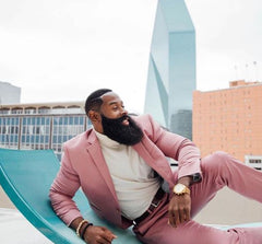 Man with long beard in a pink suit