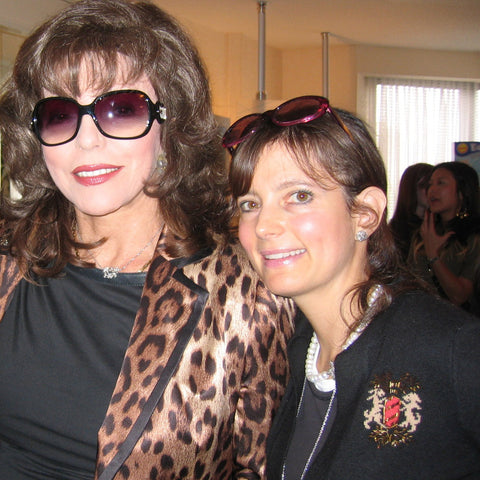 Joan Collins with co-owner Randi Herlich, wearing her vintage fleur necklace