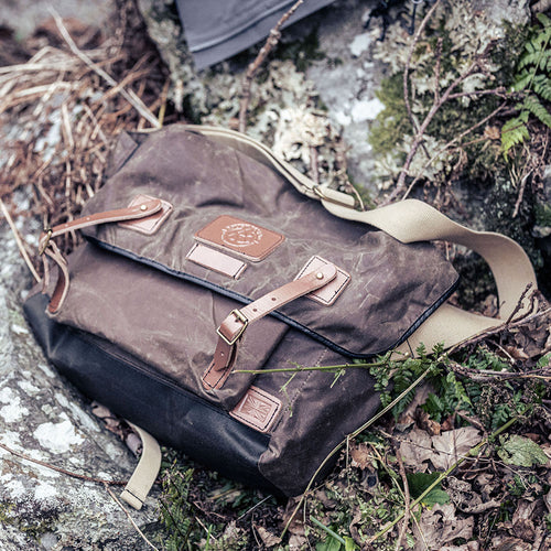 Gubbins messenger bag lying on rocks
