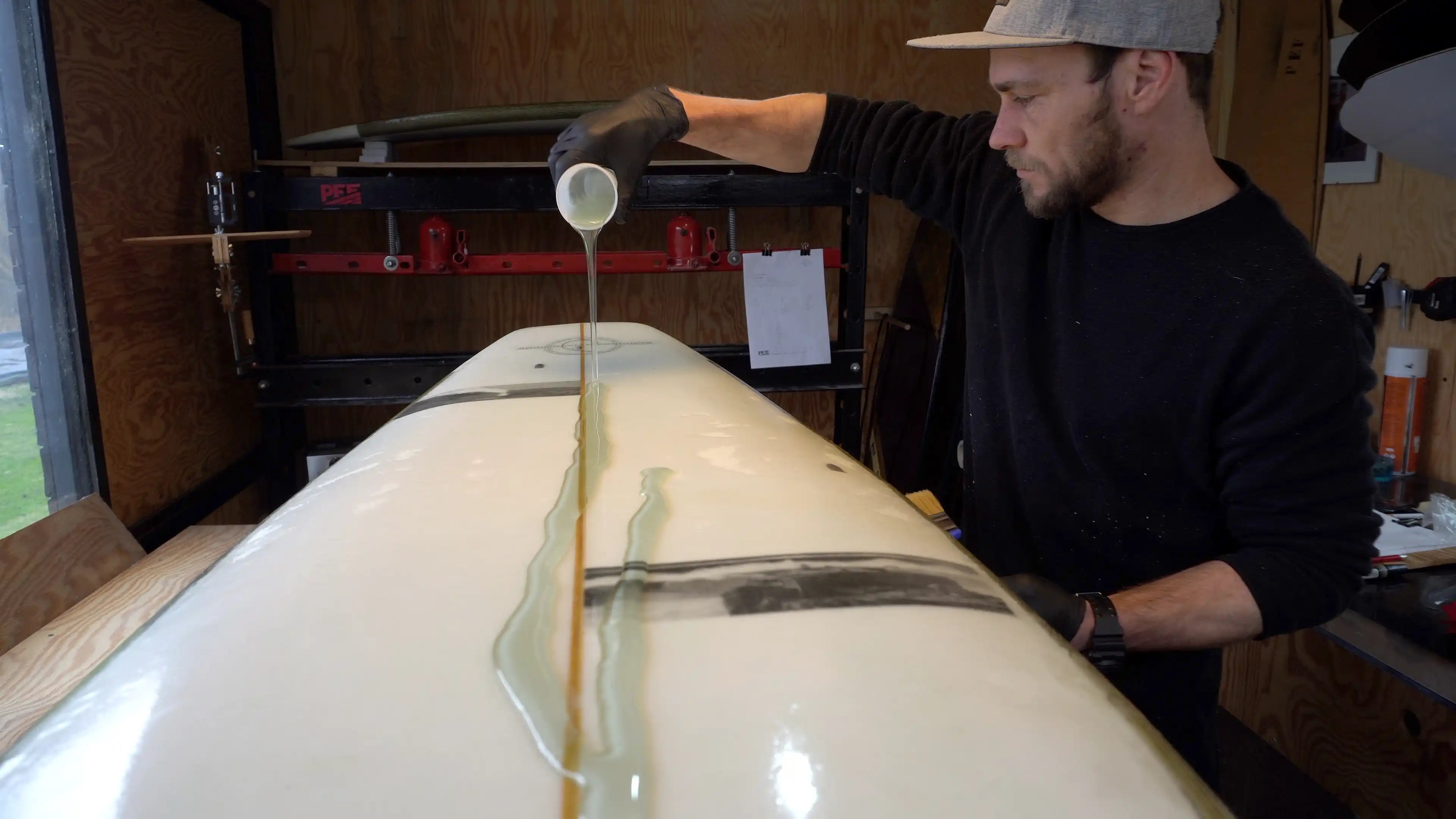 Shaper Martin Brandýs stands in his workshop, P.E.F. surfboards, river surfboard shaper, sheep