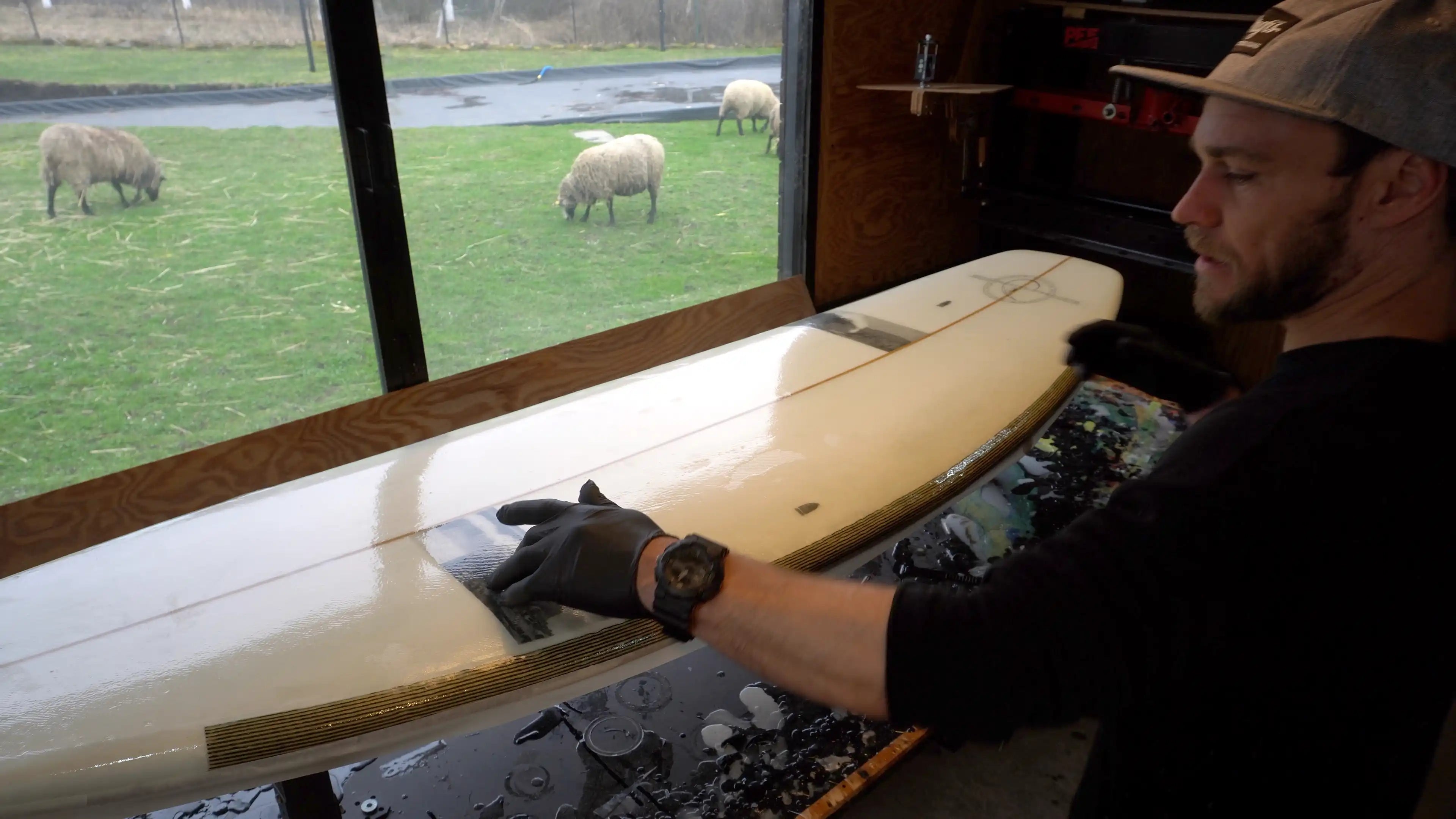 Shaper Martin Brandýs stands in his workshop, P.E.F. surfboards, river surfboard shaper, sheep