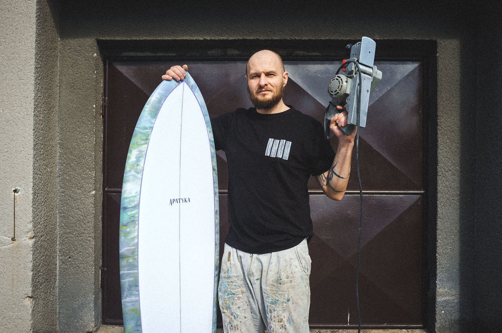 Apatyka Surfboards, Milos Potuzak, shaper stands in front of the garage