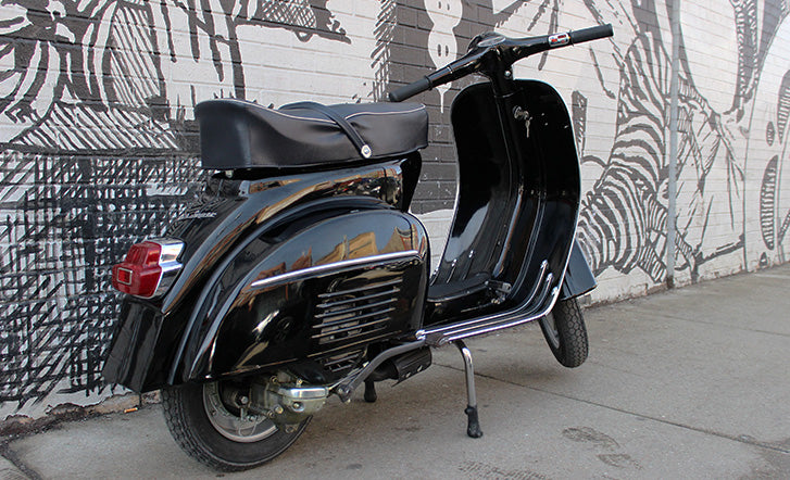 Vespa Super, chilling out by a wall, looking all brand new