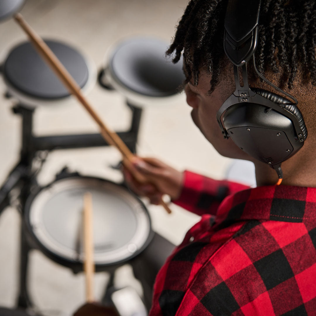 Drummer playing with headphones