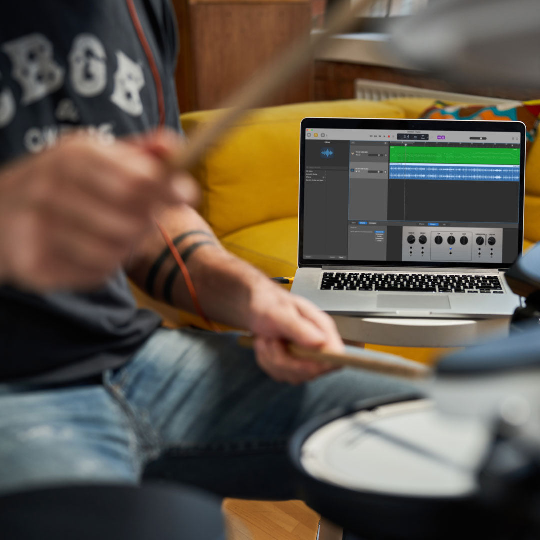 Drummer using recording software on a laptop computer while playing the TD-02KV