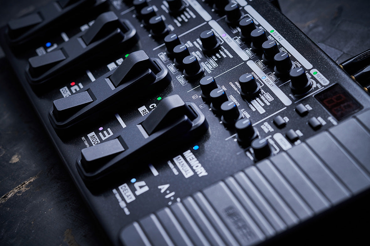 A view from the right of the expression pedal, footswitches, and knobs on the top panel of the unit.