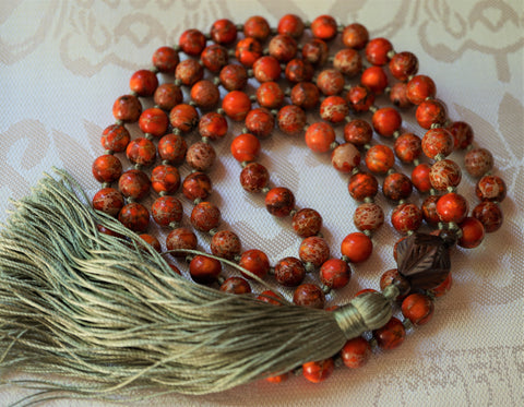 orange jasper mala. 108 beads plus carved wooden guru and silk green tassel