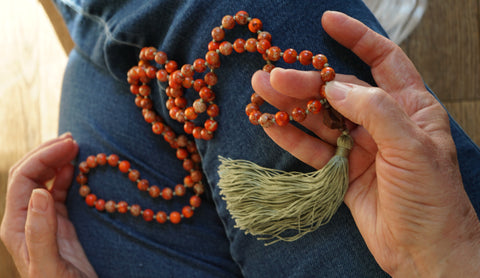 use right thumb and middle finger to gently press each bead in mala