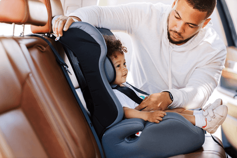 A father and his baby in car seat