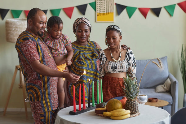 African family lighting Kwanzaa candles