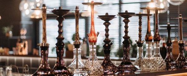 Hookahs and Pipes lined up on a table