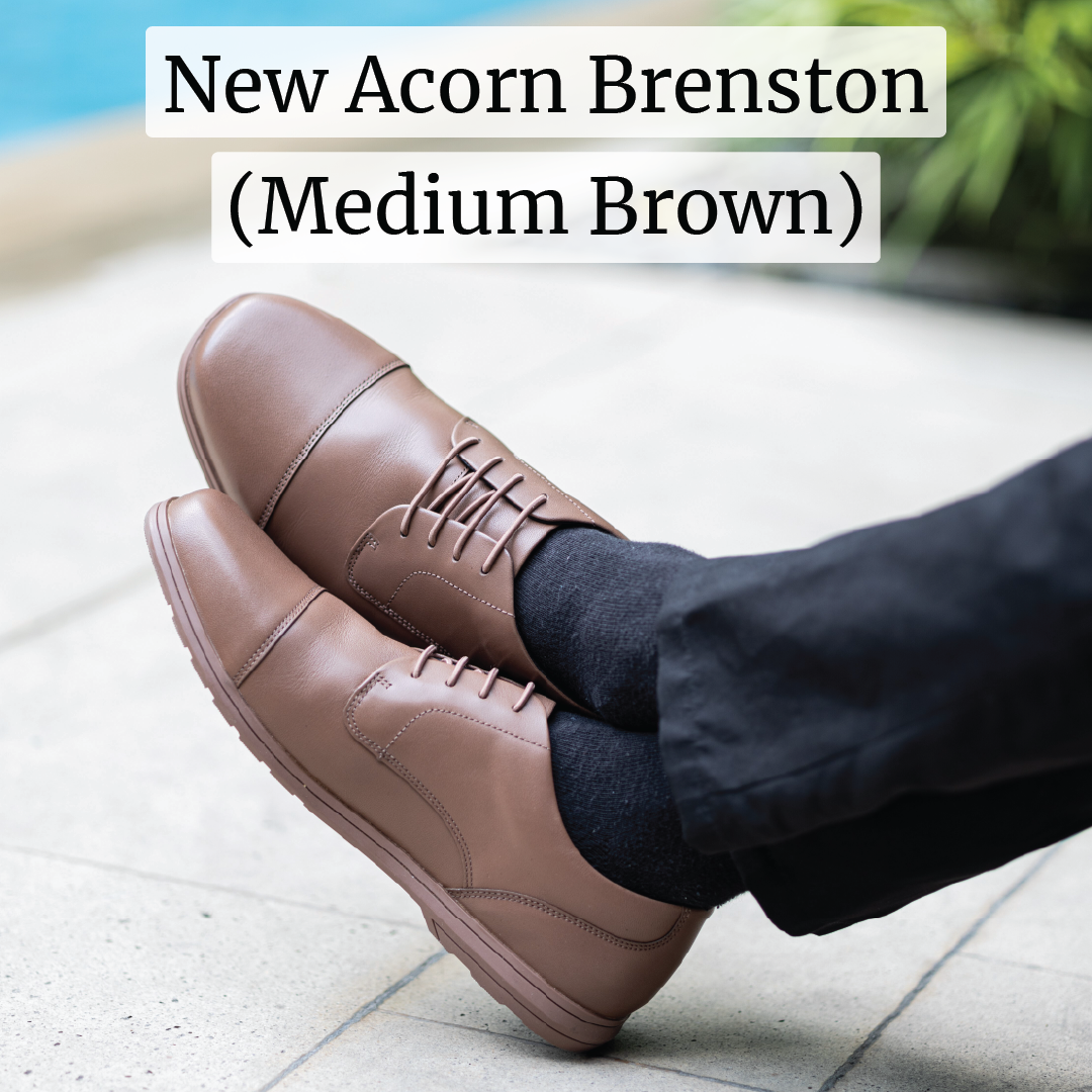 A pair of medium brown dress shoes with the text 'New Acorn Brenston' displayed above.