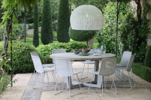 Luxury patio with wicker dining furniture and teak table